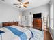 Spacious bedroom featuring hardwood floors, ceiling fan, and ample natural light at 16863 Se 110Th Court Rd, Summerfield, FL 34491