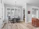 Bright breakfast area with wood floors, plantation shutters, and a chandelier fixture at 16863 Se 110Th Court Rd, Summerfield, FL 34491