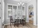 Bright breakfast area with wood floors, plantation shutters, and a chandelier fixture at 16863 Se 110Th Court Rd, Summerfield, FL 34491