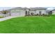 Well-maintained home featuring a manicured lawn and lovely flower beds at 16863 Se 110Th Court Rd, Summerfield, FL 34491