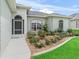 Close-up view of a home with an attractive flower bed and manicured lawn at 16863 Se 110Th Court Rd, Summerfield, FL 34491