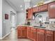 Elegant kitchen features wood cabinets, granite countertops, and stainless steel appliances at 16863 Se 110Th Court Rd, Summerfield, FL 34491