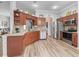 Well-appointed kitchen boasts wood cabinetry, stainless steel appliances and stylish countertops at 16863 Se 110Th Court Rd, Summerfield, FL 34491