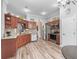 Modern kitchen featuring stainless steel appliances and wood cabinetry for ample storage at 16863 Se 110Th Court Rd, Summerfield, FL 34491
