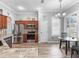 Well-lit kitchen featuring stainless steel appliances, wood cabinets, granite countertops, and a cozy breakfast nook at 16863 Se 110Th Court Rd, Summerfield, FL 34491