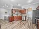 Open kitchen with wood cabinets, stainless steel appliances, and hardwood floor at 16863 Se 110Th Court Rd, Summerfield, FL 34491