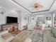 Cozy living room featuring hardwood floors, tray ceiling, and view to breakfast area at 16863 Se 110Th Court Rd, Summerfield, FL 34491