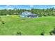 Sprawling property with a beautiful home, lush landscaping, mature trees, and an in-ground pool at 1702 Hidden Palms Dr, Davenport, FL 33897