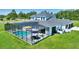 Aerial view of a large pool and outdoor living area with a screened enclosure at 1702 Hidden Palms Dr, Davenport, FL 33897