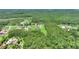 Aerial view of the home nestled within a lush forest, offering privacy and tranquility at 1702 Hidden Palms Dr, Davenport, FL 33897