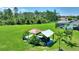 An aerial view of a backyard area with an outdoor kitchen and lush landscaping at 1702 Hidden Palms Dr, Davenport, FL 33897