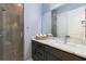 Modern bathroom with a glass-enclosed shower, dark vanity, and stylish fixtures at 1702 Hidden Palms Dr, Davenport, FL 33897