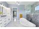Modern bathroom complete with soaking tub, a separate shower, and white cabinets at 1702 Hidden Palms Dr, Davenport, FL 33897