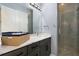 Bathroom with dual sinks, stone countertops, and glass enclosed shower at 1702 Hidden Palms Dr, Davenport, FL 33897