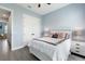 Bedroom with gray wood floors, closet, and view into the hall at 1702 Hidden Palms Dr, Davenport, FL 33897