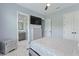 Comfortable bedroom boasts TV, adjacent bathroom, and double-door closet at 1702 Hidden Palms Dr, Davenport, FL 33897