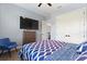 Comfortable bedroom features a large TV, closet and blue decor at 1702 Hidden Palms Dr, Davenport, FL 33897