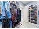 Spacious walk-in closet with custom shelving, ample hanging space, and marble flooring at 1702 Hidden Palms Dr, Davenport, FL 33897
