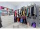 Large walk-in closet with custom shelving, drawers, and a comfortable ottoman at 1702 Hidden Palms Dr, Davenport, FL 33897