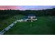 Aerial view of a home with a long driveway, mature landscaping, and expansive lawn at 1702 Hidden Palms Dr, Davenport, FL 33897