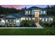 Well-lit modern two-story home with manicured lawn and landscaped walkway leading to front door at 1702 Hidden Palms Dr, Davenport, FL 33897