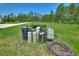This property features an irrigation system and a lush lawn surrounded by a beautiful wooded backdrop at 1702 Hidden Palms Dr, Davenport, FL 33897