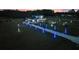 Aerial view of a large home with holiday decorations and lights lining the palm-tree-lined driveway at 1702 Hidden Palms Dr, Davenport, FL 33897