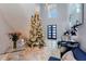 Spacious foyer with high ceilings, marble floors, and a grand Christmas tree as a focal point at 1702 Hidden Palms Dr, Davenport, FL 33897