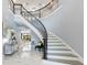 Bright foyer with winding staircase and elegant marble floors at 1702 Hidden Palms Dr, Davenport, FL 33897