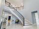 Bright foyer with winding staircase and elegant marble floors at 1702 Hidden Palms Dr, Davenport, FL 33897