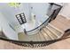 Grand two-story foyer boasts winding staircase and modern tile floors at 1702 Hidden Palms Dr, Davenport, FL 33897