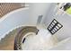 Two-story foyer with winding staircase, chandelier, and modern tile flooring at 1702 Hidden Palms Dr, Davenport, FL 33897