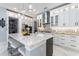 Updated kitchen with white cabinets, marble island, stainless steel appliances, and ample storage space, perfect for any chef at 1702 Hidden Palms Dr, Davenport, FL 33897