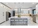 Bright, modern kitchen with white cabinetry, a central island with seating, and stainless steel appliances and fixtures at 1702 Hidden Palms Dr, Davenport, FL 33897