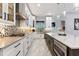 Gourmet kitchen featuring an island with bar seating, sleek cabinetry, modern appliances, and mosaic backsplash at 1702 Hidden Palms Dr, Davenport, FL 33897