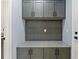 A well organized laundry room complete with overhead cabinets and stylish countertop at 1702 Hidden Palms Dr, Davenport, FL 33897