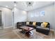 Comfortable living room featuring a large sectional sofa, modern lighting, and wood floors at 1702 Hidden Palms Dr, Davenport, FL 33897