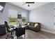 Bright home office with a large window, comfortable seating, and modern desk at 1702 Hidden Palms Dr, Davenport, FL 33897
