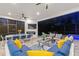 This screened patio has comfortable lounge seating, a dining area, and a fireplace with TV, creating an inviting outdoor living space at 1702 Hidden Palms Dr, Davenport, FL 33897