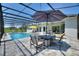 Private pool and patio area featuring outdoor dining and lounge chairs at 1702 Hidden Palms Dr, Davenport, FL 33897