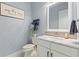 Stylish powder room featuring marble countertop, decorative backsplash, and modern fixtures at 1702 Hidden Palms Dr, Davenport, FL 33897