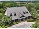 An aerial view of a home with a metal roof, dormer windows, and well-manicured landscaping at 20945 Oldenburg Loop, Mount Dora, FL 32757