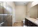 Bathroom featuring a walk-in shower, dark vanity, and tile floors at 20945 Oldenburg Loop, Mount Dora, FL 32757