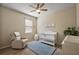 Bedroom with neutral walls, wood floors, a crib, and a rocking chair at 20945 Oldenburg Loop, Mount Dora, FL 32757