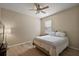 Cozy bedroom with hardwood floors, a ceiling fan, and a window providing natural light at 20945 Oldenburg Loop, Mount Dora, FL 32757