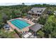 Aerial view of community pool with lap lanes, sun loungers, and a stylish clubhouse at 20945 Oldenburg Loop, Mount Dora, FL 32757