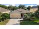 Charming home with a two-car garage, well-manicured lawn, and inviting entrance at 20945 Oldenburg Loop, Mount Dora, FL 32757