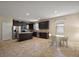 Beautiful kitchen featuring stainless steel appliances, dark wood cabinets, and tile floors at 20945 Oldenburg Loop, Mount Dora, FL 32757