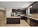 Bright kitchen features an island, stainless steel appliances, tile backsplash, and plenty of cabinet space at 20945 Oldenburg Loop, Mount Dora, FL 32757