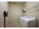 A bright laundry room with a full-sized washer and dryer at 20945 Oldenburg Loop, Mount Dora, FL 32757